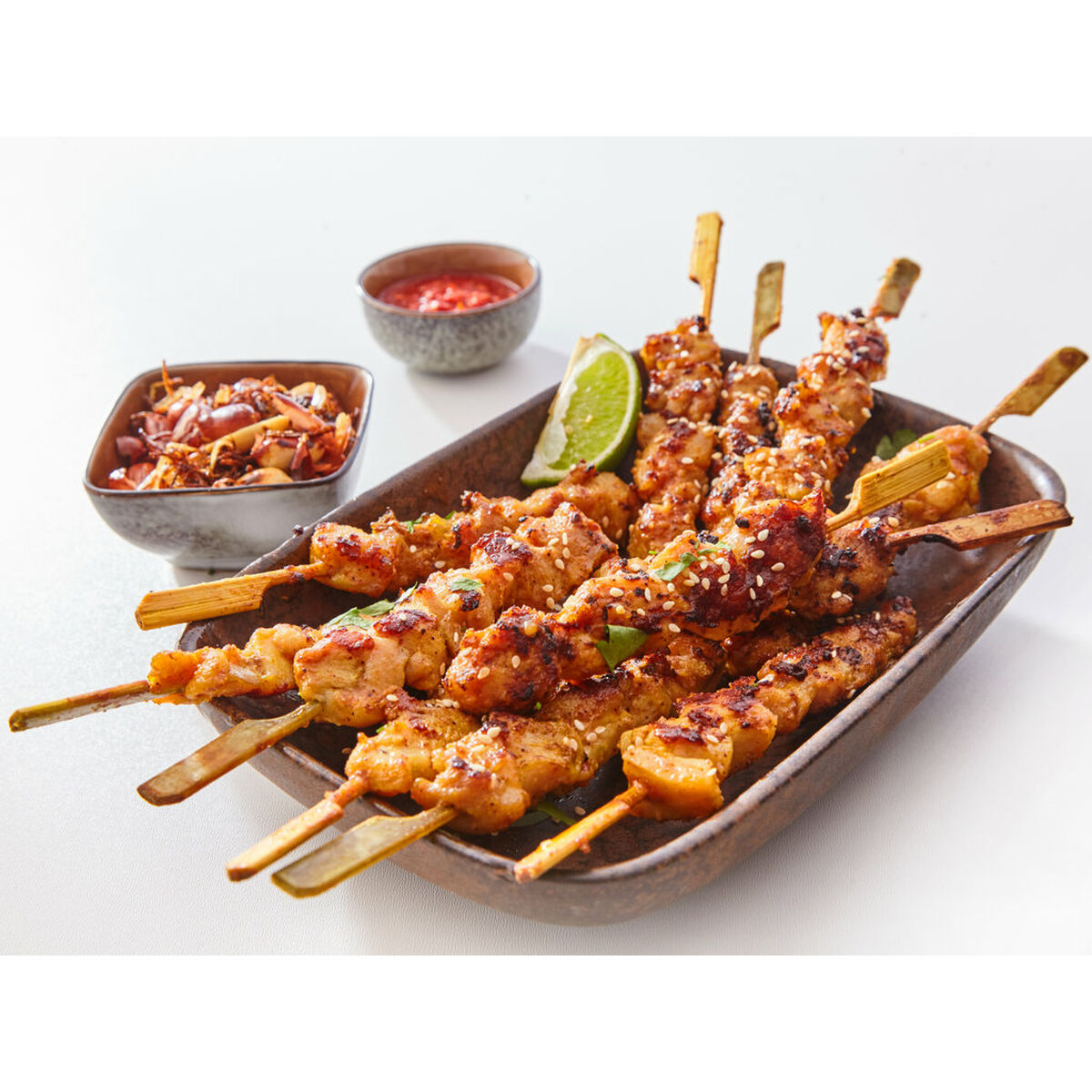 Close Up Still Life of Dish of Grilled Pork or Chicken on Wooden Skewers with Lime Garnish and Sauce on White Studio Background S2238220_3